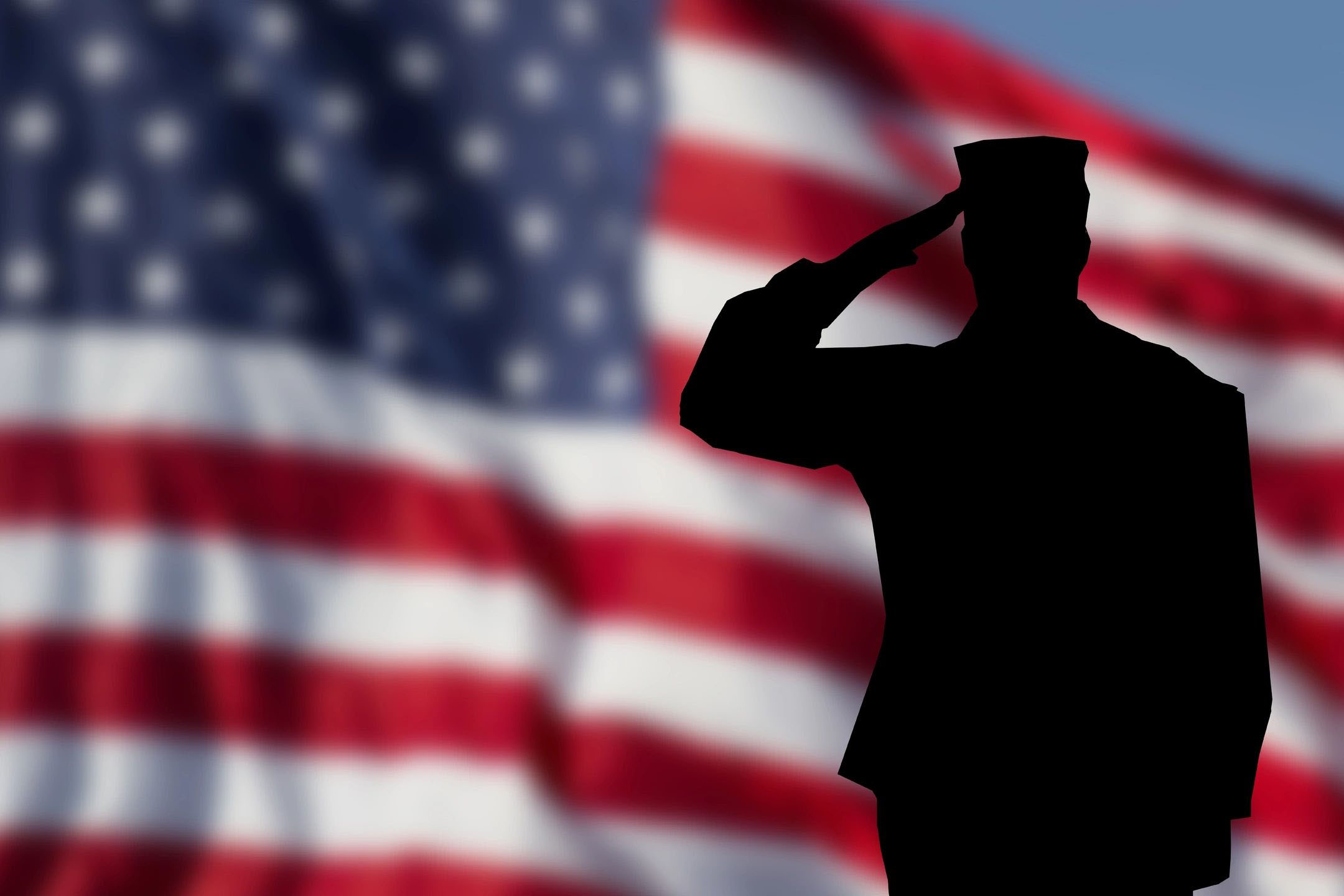 a cutout of a man saluting and Flag in the background